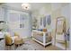 Charming Bedroom with a crib, accent wall, a comfortable armchair, and a soft rug creating a cozy space at 2855 S Pancratia St, Denver, CO 80236