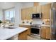 Well-lit kitchen with modern appliances, including a stainless steel range, ample counter space, and a stylish faucet at 2855 S Pancratia St, Denver, CO 80236