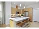 Modern kitchen featuring sleek cabinets, stainless steel appliances, a central island with a white countertop, and stylish seating at 2855 S Pancratia St, Denver, CO 80236