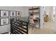 Stylish upper landing featuring a cozy study nook with built-in shelving and a view of the entryway at 2855 S Pancratia St, Denver, CO 80236