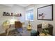 Cozy office with carpet, light wood desk, window, chair, guitar, and decor at 2855 S Pancratia St, Denver, CO 80236