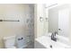 Modern bathroom featuring a gray and white marble-tiled shower, white toilet, and sink with updated fixtures at 3608 W Radcliff Ave, Denver, CO 80236