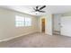 A bedroom featuring a ceiling fan, neutral walls, carpet flooring, a large window, and a closet at 3608 W Radcliff Ave, Denver, CO 80236