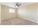 Neutral bedroom with carpet, a ceiling fan, and a window with shutters for light control at 3608 W Radcliff Ave, Denver, CO 80236