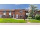 Inviting brick townhome showcasing a lovely front lawn and appealing facade at 3608 W Radcliff Ave, Denver, CO 80236