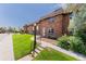 Charming brick townhome featuring a well-manicured lawn and inviting entryway at 3608 W Radcliff Ave, Denver, CO 80236