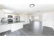 Modern kitchen with a view to an adjacent living area and stainless steel appliances at 3608 W Radcliff Ave, Denver, CO 80236