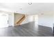 Open-concept living area featuring sleek floors and natural light from the entry door at 3608 W Radcliff Ave, Denver, CO 80236