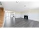 Spacious living room with hardwood floors and a cozy fireplace at 3608 W Radcliff Ave, Denver, CO 80236