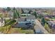 Aerial shot showcasing a two-story home, mature trees, and a spacious backyard at 8225 S Cody St, Littleton, CO 80128