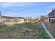 A large backyard with retaining wall and view of neighboring houses at 8225 S Cody St, Littleton, CO 80128