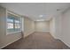 Unfurnished basement room with carpet, a window, and paneled walls at 8225 S Cody St, Littleton, CO 80128