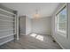 Cozy bedroom features hardwood floors, a built-in bookshelf, and ample natural light at 8225 S Cody St, Littleton, CO 80128