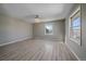 Spacious bedroom featuring hardwood floors, contemporary ceiling fan, and a mountain view at 8225 S Cody St, Littleton, CO 80128