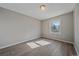 Sunlit bedroom with hardwood floors, and a window looking out onto the neighborhood at 8225 S Cody St, Littleton, CO 80128