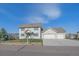 Charming two-story home with a well-maintained lawn and a convenient two-car garage at 8225 S Cody St, Littleton, CO 80128