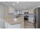 Well-lit kitchen with quartz countertops, stainless steel appliances and white cabinets at 8225 S Cody St, Littleton, CO 80128