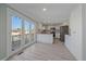 Bright kitchen features stainless steel appliances, light countertops, and access to the back deck at 8225 S Cody St, Littleton, CO 80128