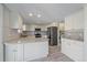 Spacious kitchen with white cabinets, stainless steel appliances, and tiled backsplash at 8225 S Cody St, Littleton, CO 80128