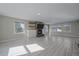 Bright living room features a fireplace, large windows, and light wood-look floors at 8225 S Cody St, Littleton, CO 80128