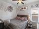 Cozy bedroom featuring a queen bed with gray bedding, ceiling fan, and decorative wall art at 402 Harrison Ave, Fort Lupton, CO 80621