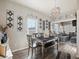 Inviting dining area with sleek, modern decor, bench seating and hardwood floors at 402 Harrison Ave, Fort Lupton, CO 80621