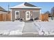 Exterior front view of home with light gray vinyl siding and charming white trim at 402 Harrison Ave, Fort Lupton, CO 80621