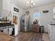 Well-lit kitchen with stainless steel appliances, light countertops and wood floors at 402 Harrison Ave, Fort Lupton, CO 80621