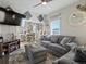 Comfortable living room featuring a cozy sofa, modern decor, and bright dining space at 402 Harrison Ave, Fort Lupton, CO 80621