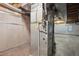 Basement showcasing the furnace with concrete walls, exposed ducts and ceiling joists, and small casement window at 17664 E Loyola Dr # C, Aurora, CO 80013