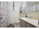 Bright bathroom featuring a vanity, medicine cabinet, and shower with a patterned curtain at 17664 E Loyola Dr # C, Aurora, CO 80013