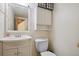 Cozy powder room featuring vanity sink, commode, medicine cabinet and simple decor at 17664 E Loyola Dr # C, Aurora, CO 80013