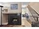 Inviting fireplace with adjacent stairs at 17664 E Loyola Dr # C, Aurora, CO 80013