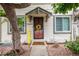 Charming townhome with a decorative wreath on the front door and a cheerful welcome sign at 17664 E Loyola Dr # C, Aurora, CO 80013