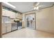 Bright kitchen with neutral cabinetry, stainless steel appliances, and sliding door leading to a deck or patio area at 17664 E Loyola Dr # C, Aurora, CO 80013