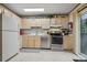 Neutral toned kitchen with stainless steel appliances, light cabinets and tile floors at 17664 E Loyola Dr # C, Aurora, CO 80013