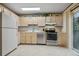 Functional kitchen with a full suite of appliances, ample cabinetry, and access to outdoor space at 17664 E Loyola Dr # C, Aurora, CO 80013
