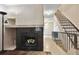 Living room features a cozy fireplace with tile surround, creating an inviting focal point, and leads to an open staircase at 17664 E Loyola Dr # C, Aurora, CO 80013