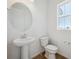 Clean half bathroom with pedestal sink, toilet, and window at 1374 Penner Dr, Erie, CO 80026