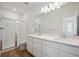 Bathroom featuring double sink vanity, shower with glass door, and tile flooring at 1374 Penner Dr, Erie, CO 80026
