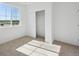 Sunlit bedroom featuring a closet and large window with backyard views at 1374 Penner Dr, Erie, CO 80026