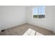 Bright bedroom with a large window overlooking outdoor greenery and neutral carpet at 1374 Penner Dr, Erie, CO 80026