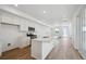 Modern kitchen featuring stainless steel appliances, hardwood floors, and a center island at 1374 Penner Dr, Erie, CO 80026