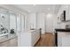 Modern kitchen with island sink, stainless steel appliances, and access to outdoor patio at 1374 Penner Dr, Erie, CO 80026