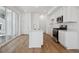 Modern kitchen with stainless steel appliances, island sink, and sliding door at 1374 Penner Dr, Erie, CO 80026