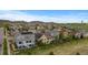 Aerial view of a residential neighborhood featuring a variety of home styles, manicured lawns, and community landscaping at 17223 W 84Th Dr, Arvada, CO 80007