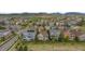 Expansive aerial view of a suburban neighborhood with tree-lined streets and homes nestled among mature trees at 17223 W 84Th Dr, Arvada, CO 80007