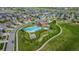 Aerial view of community pool and playground showcasing well-maintained landscaping, a gazebo, and surrounding homes at 17223 W 84Th Dr, Arvada, CO 80007