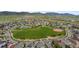 Aerial view of a residential neighborhood with lush green spaces, walking paths, and community amenities at 17223 W 84Th Dr, Arvada, CO 80007