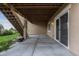 Spacious patio area featuring neutral siding, stair access to the backyard, and a sliding glass door entrance at 17223 W 84Th Dr, Arvada, CO 80007